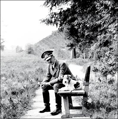 Hitler relaxing on a bench with a dog